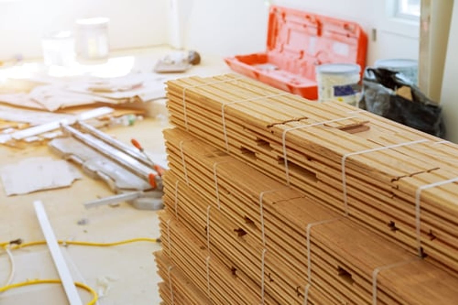 Bundles of hardwood flooring staged on site before installation in an Oklahoma City home