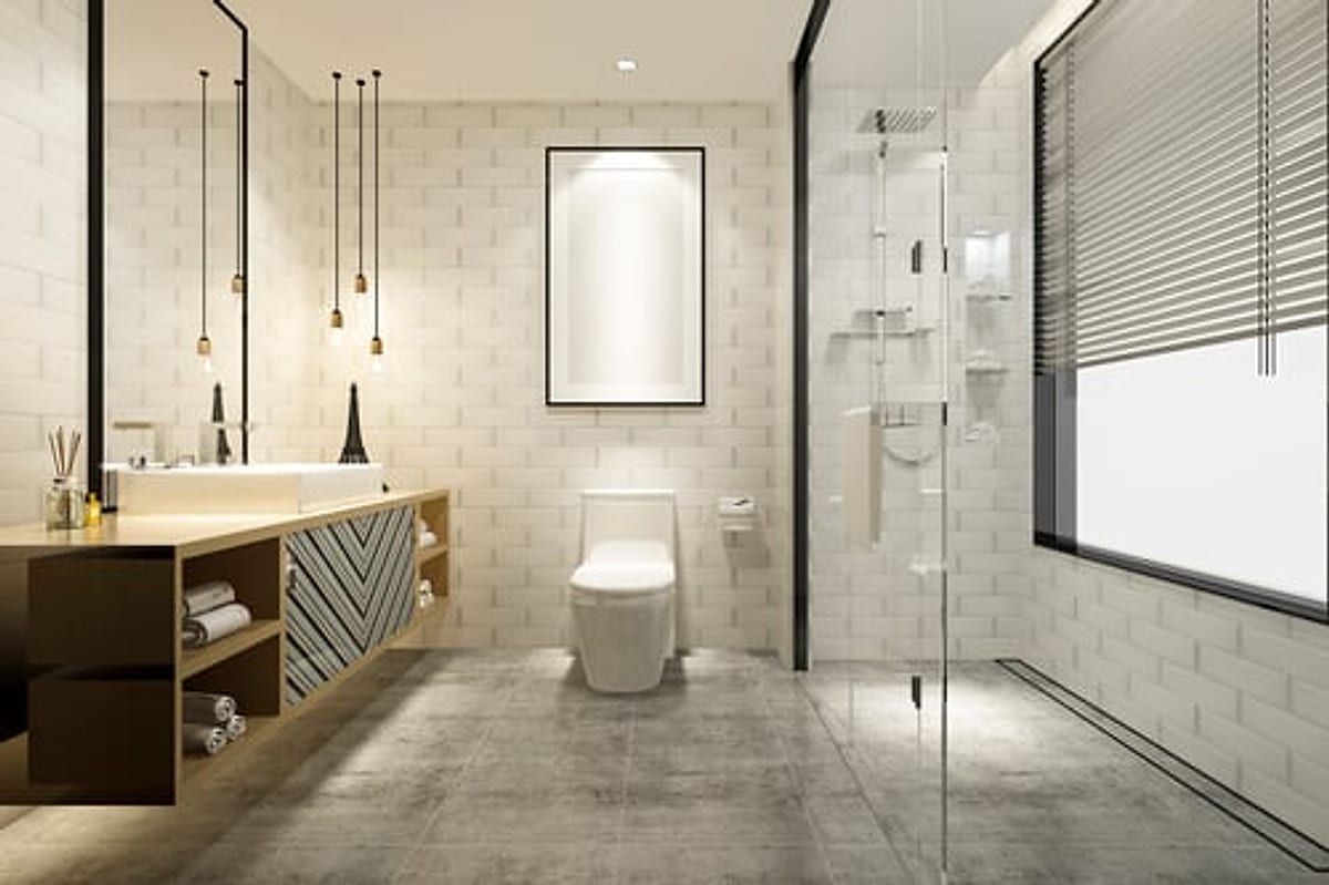 Compact modern bathroom with a floating vanity, walk-in glass shower and large-format floor tile