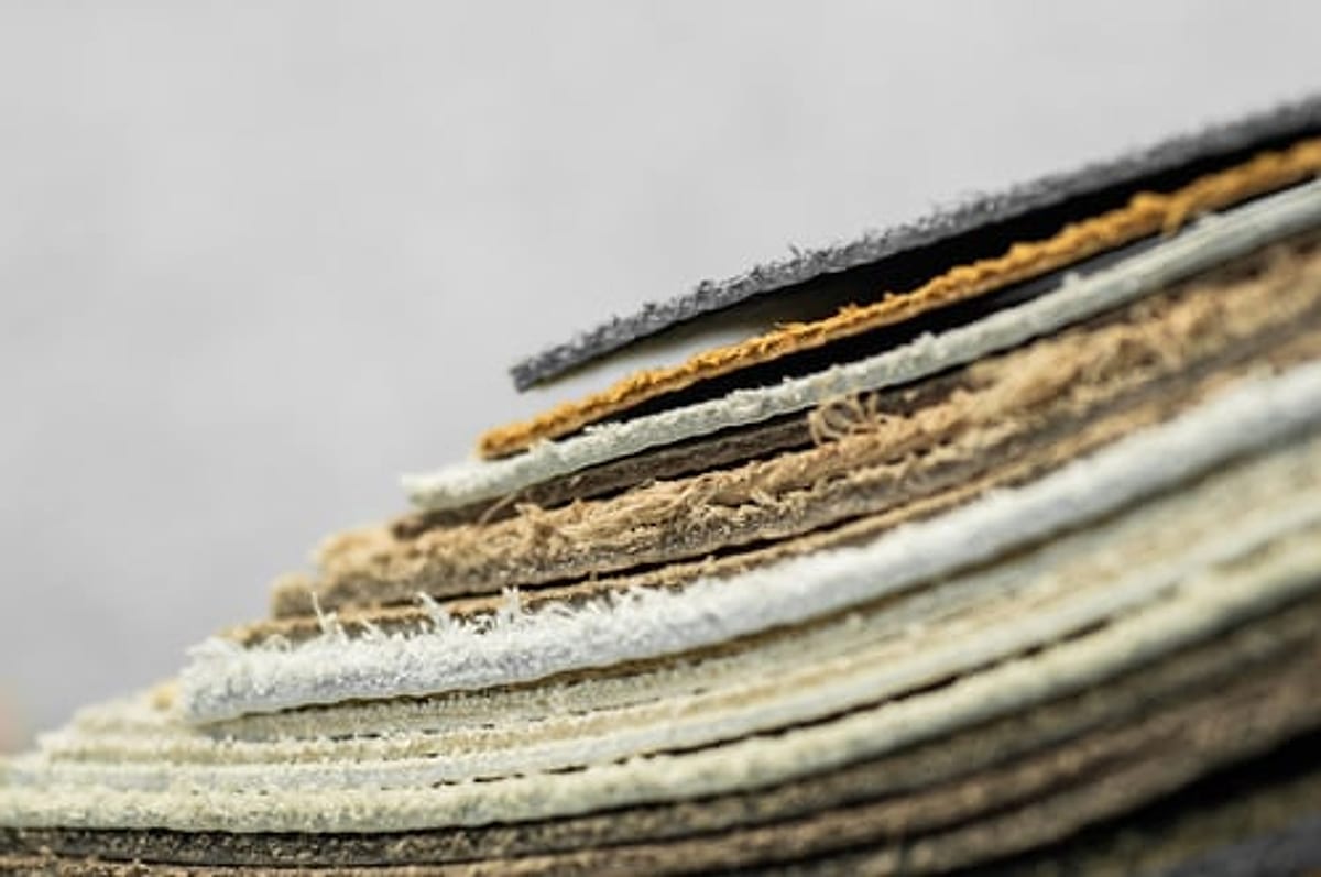 Stacked carpet samples in a range of fibers and backings for an Oklahoma City flooring project