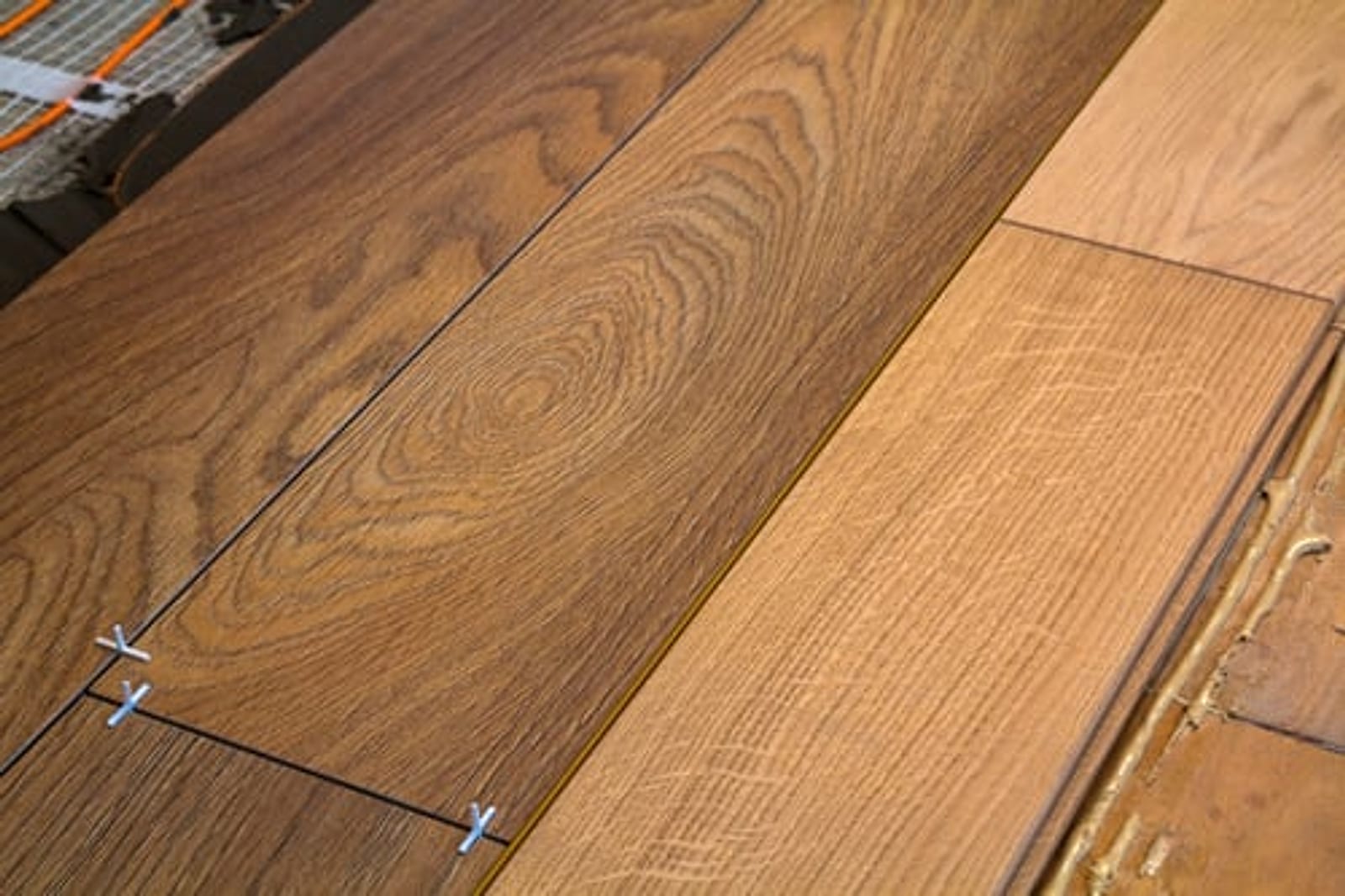 Wood-look plank flooring being installed with spacers on a prepared subfloor in Oklahoma City